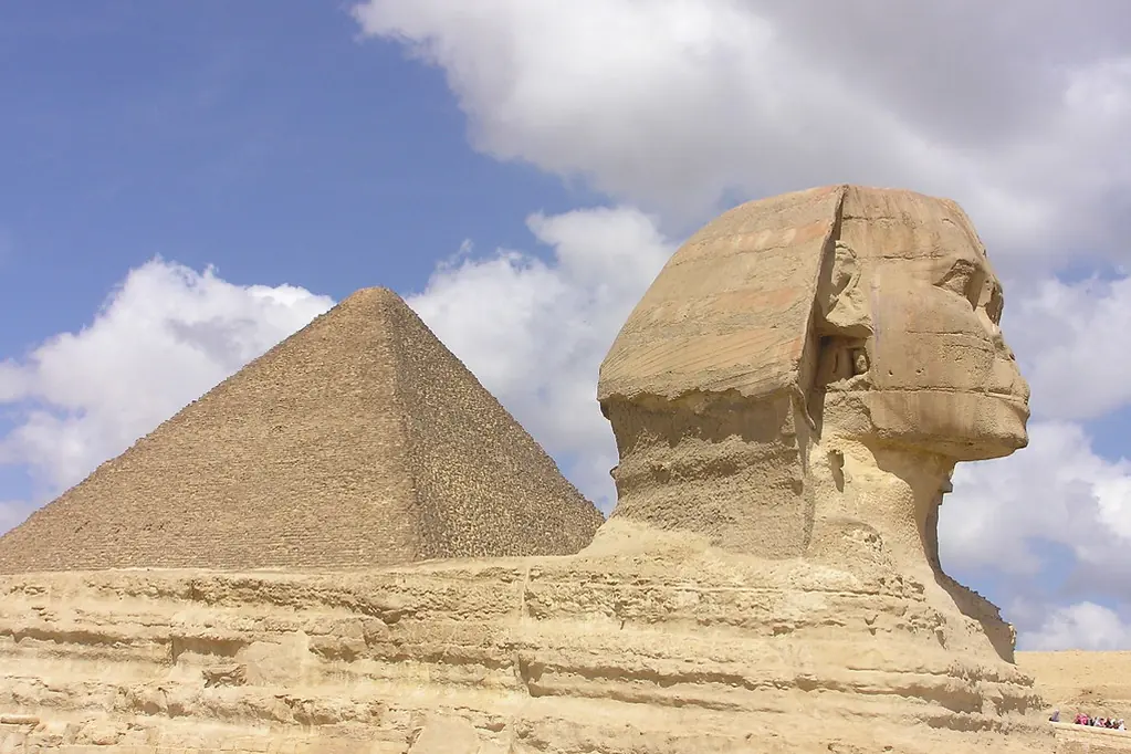 The Sphinx in profile beside the Great Pyramid