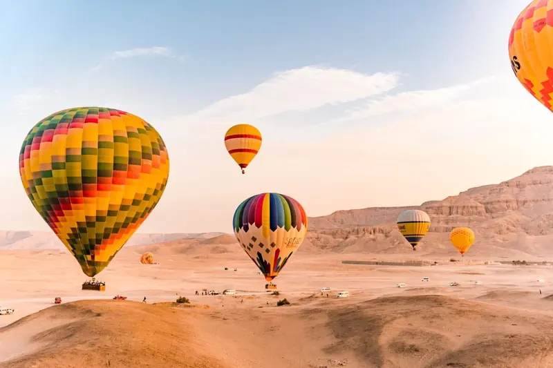 Hot air balloons rising over the desert on Luxor’s West Bank