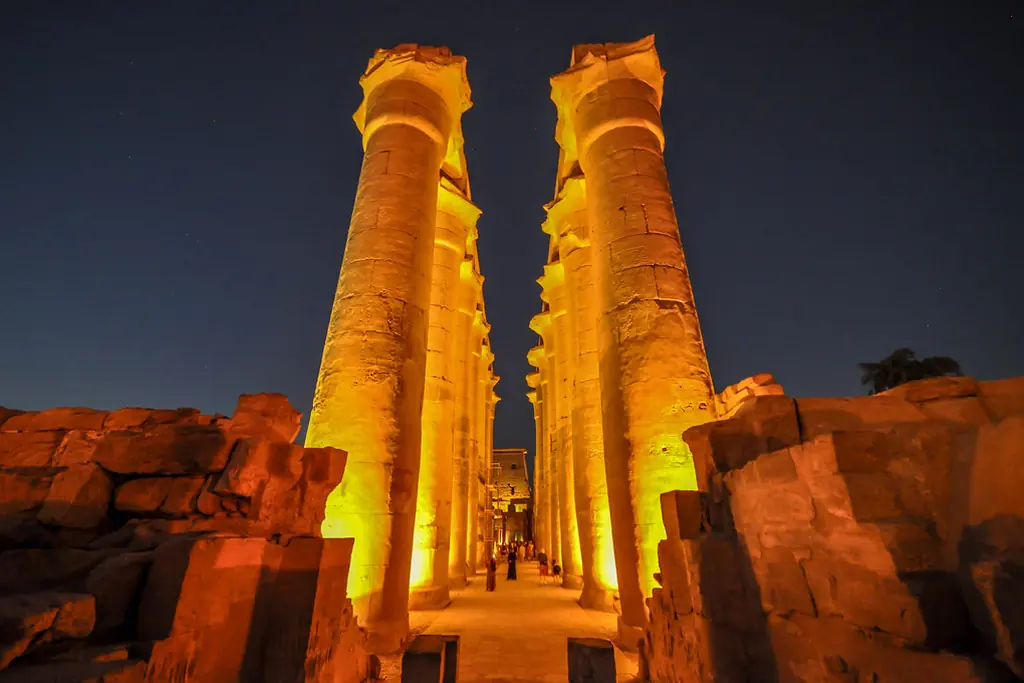 The colonnade of Luxor Temple lit at night