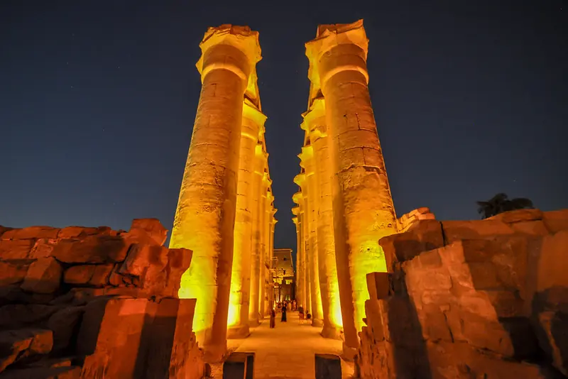 The colonnade of Luxor Temple lit at night