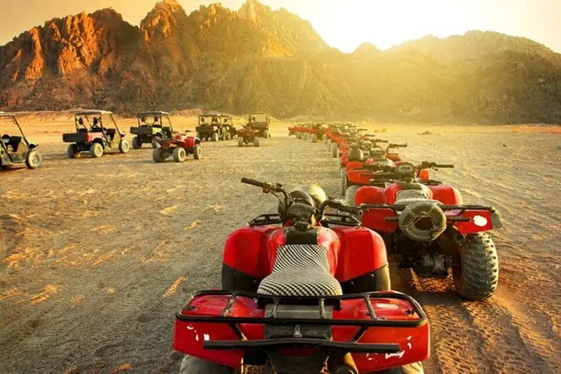 Quad bikes lined up in the desert near Hurghada at sunset
