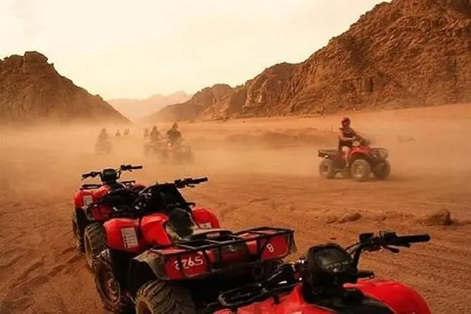 Quads kicking up dust on a desert track